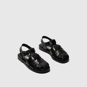 Pair of black sandals on a light gray background