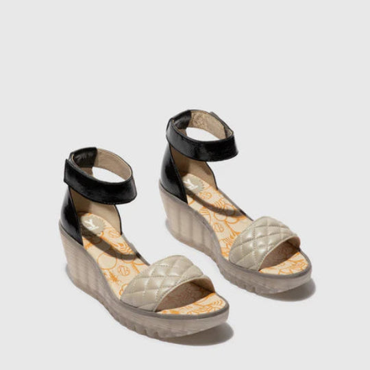 Pair of wedge sandals with quilted design 