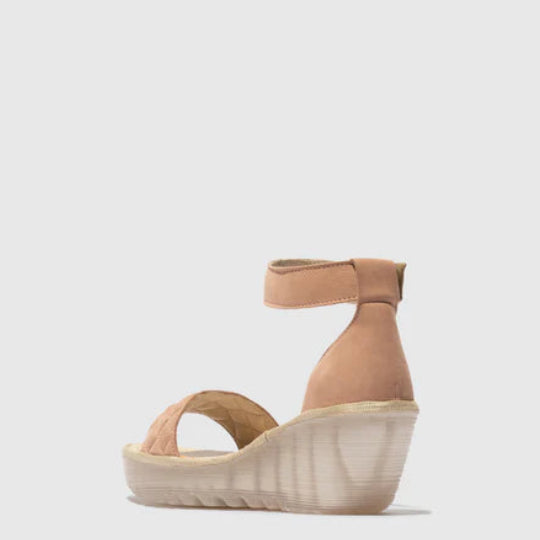Pink suede wedge sandal on a white background