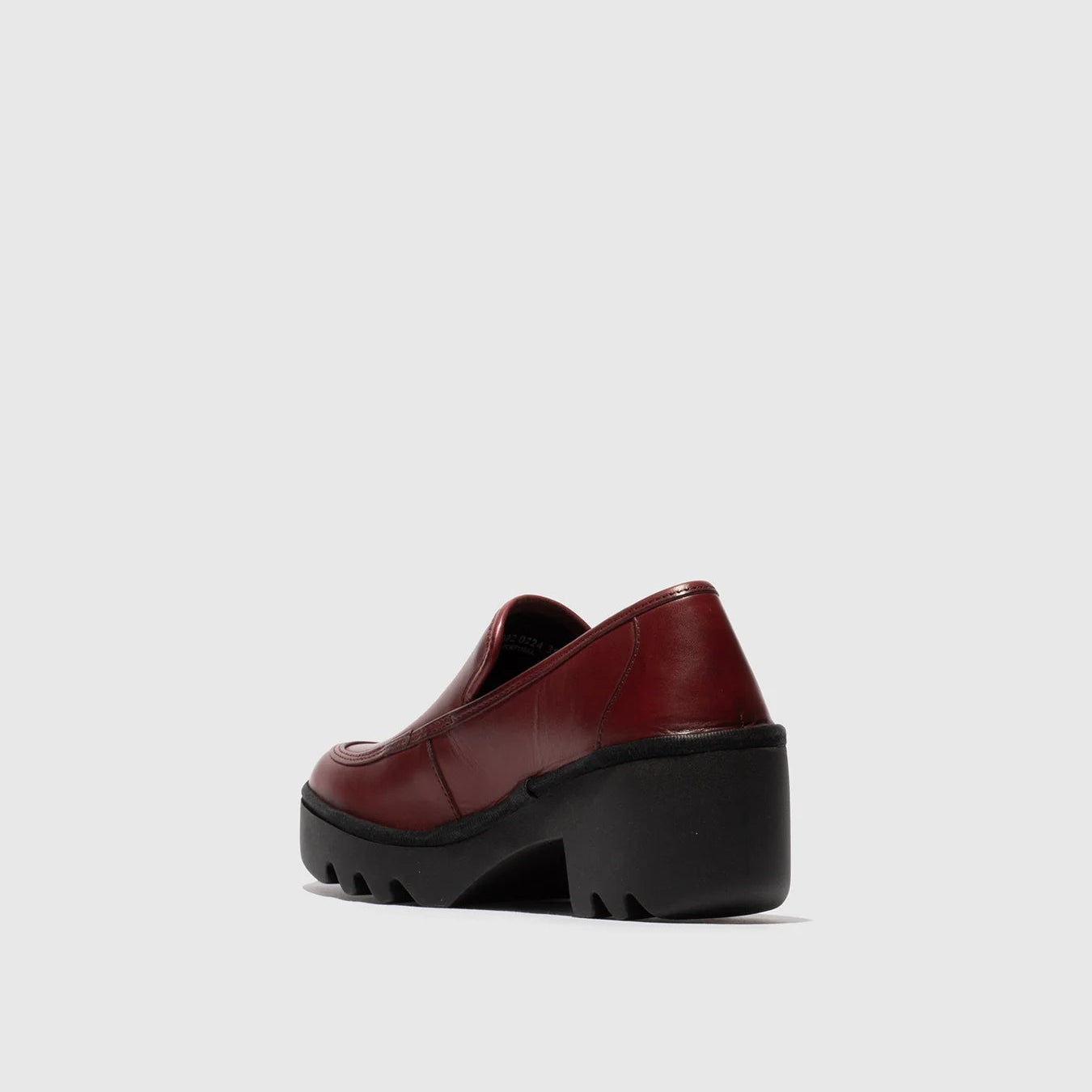 Red platform shoe on a light gray background