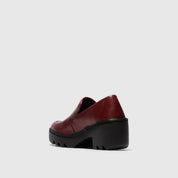 Red platform shoe on a light gray background