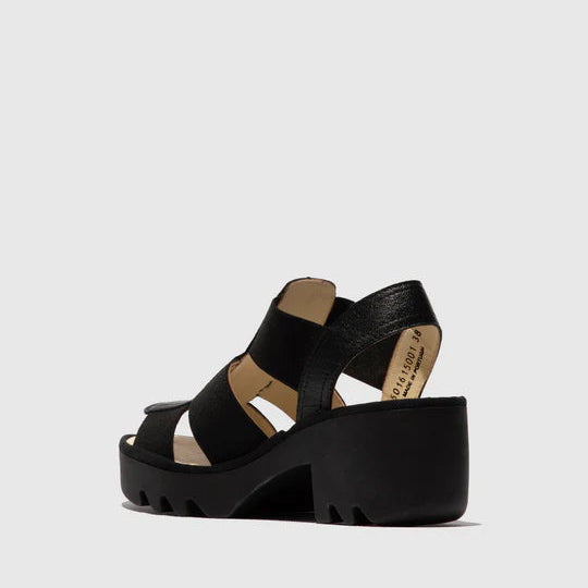 Black sandal with a platform sole on a light gray background