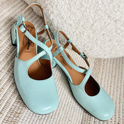 Pair of light blue shoes on a textured surface