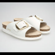 White sandals with gold buckles on a white background