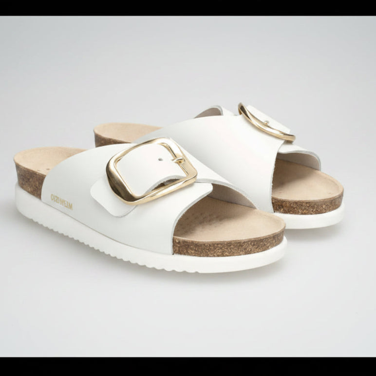 White sandals with gold buckles on a white background