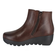 Brown leather ankle boot with a black sole on a white background