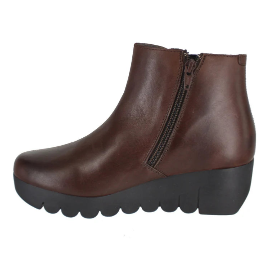 Brown leather ankle boot with a black sole on a white background