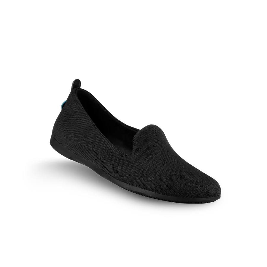 Black slip-on shoe on a white background