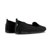Black slip-on shoes on a white background