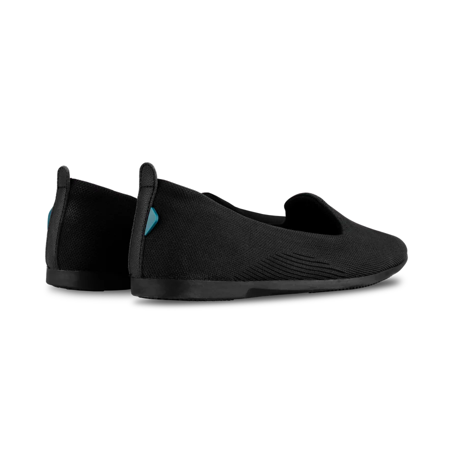 Black slip-on shoes on a white background