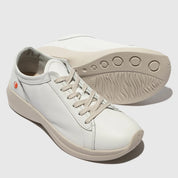 White sneakers with beige soles on a light gray background