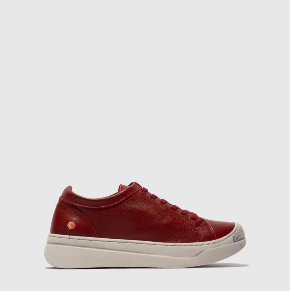 Red sneaker with white sole on a light gray background