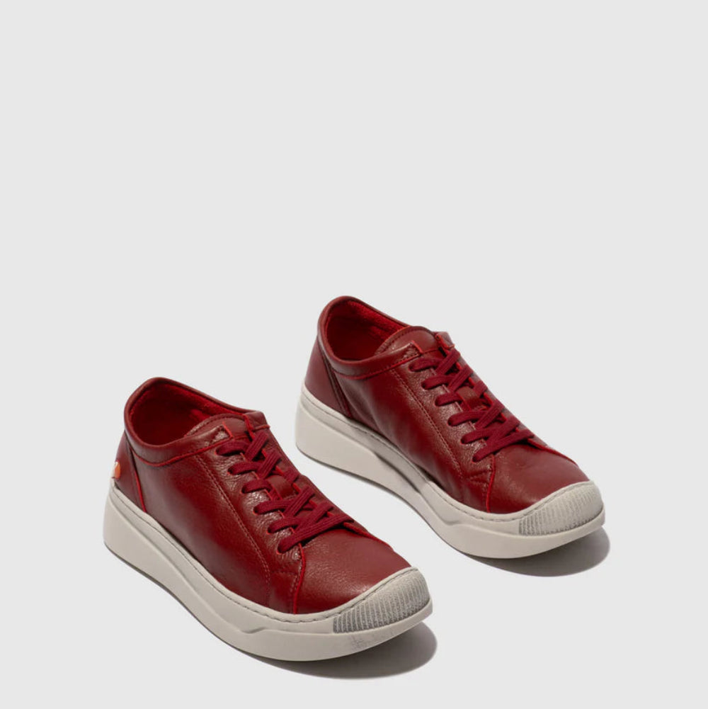 Pair of red sneakers on a white background