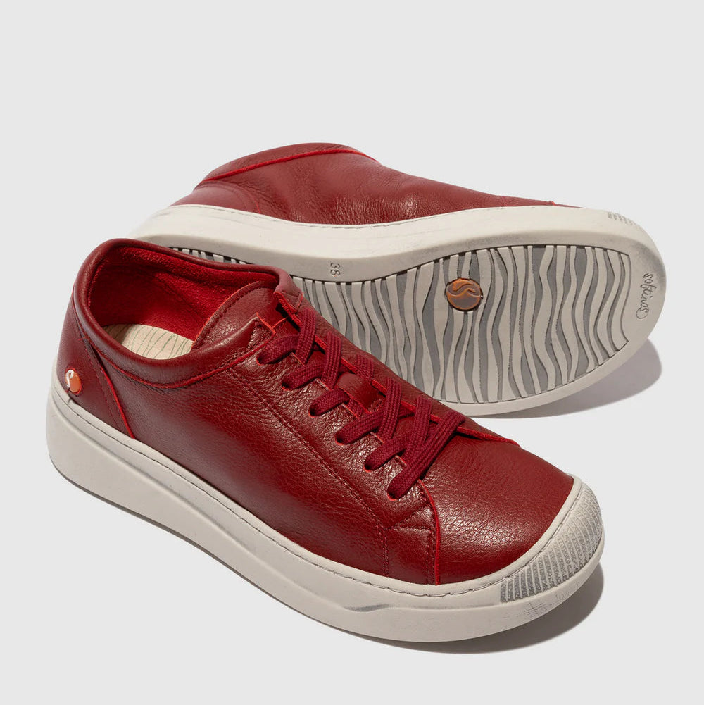 Red leather sneakers with white soles on a light gray background