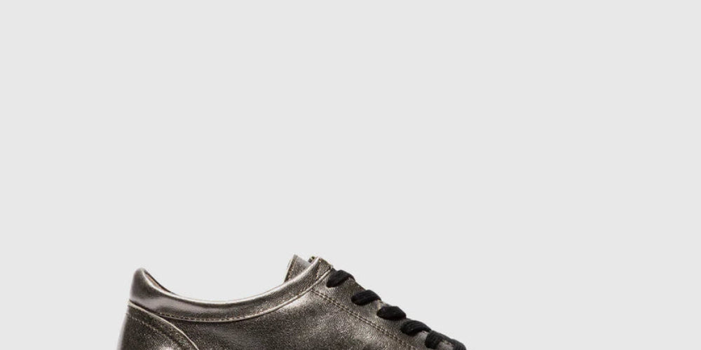 Black leather sneaker on a light gray background