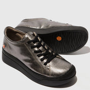 Pair of metallic silver sneakers with black soles on a light gray background