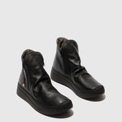 Pair of black leather boots on a white background