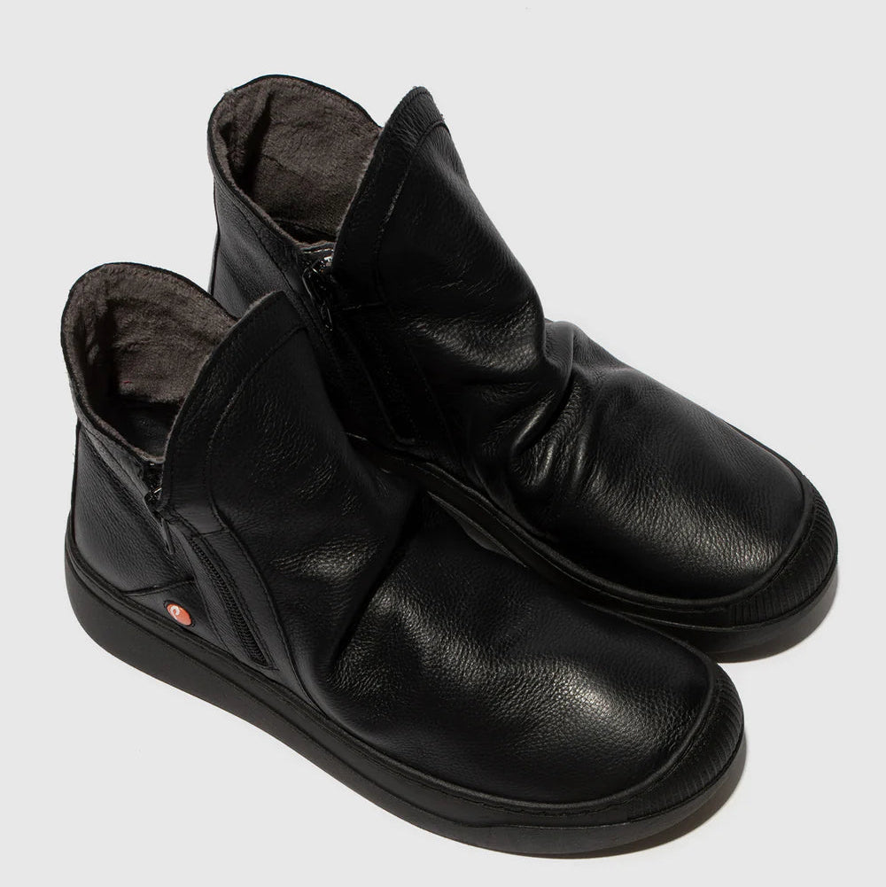 Pair of black leather ankle boots on a light gray background