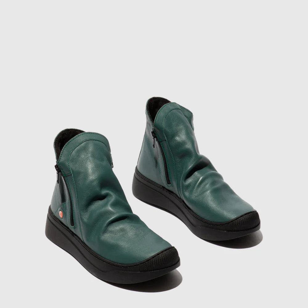 Pair of green leather shoes on a light gray background