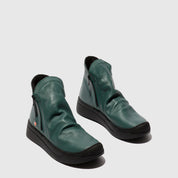 Pair of green leather shoes on a light gray background