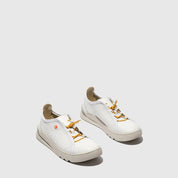 Pair of white sneakers with gold accents on a light gray background