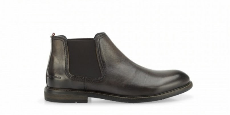 Dark brown leather Chelsea boot on a white background