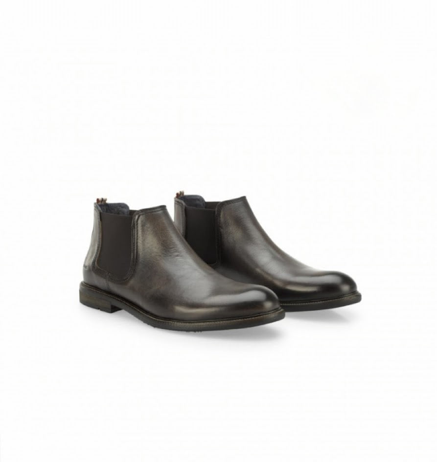 Pair of black leather Chelsea boots on a white background
