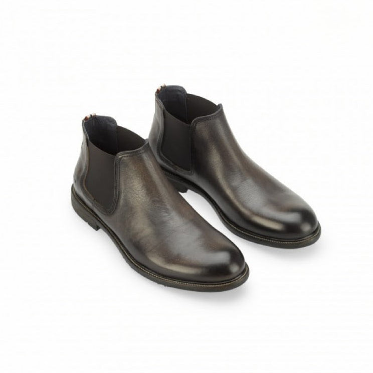 Pair of brown leather Chelsea boots on a white background