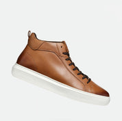 Brown leather high-top sneaker with white sole on a light gray background