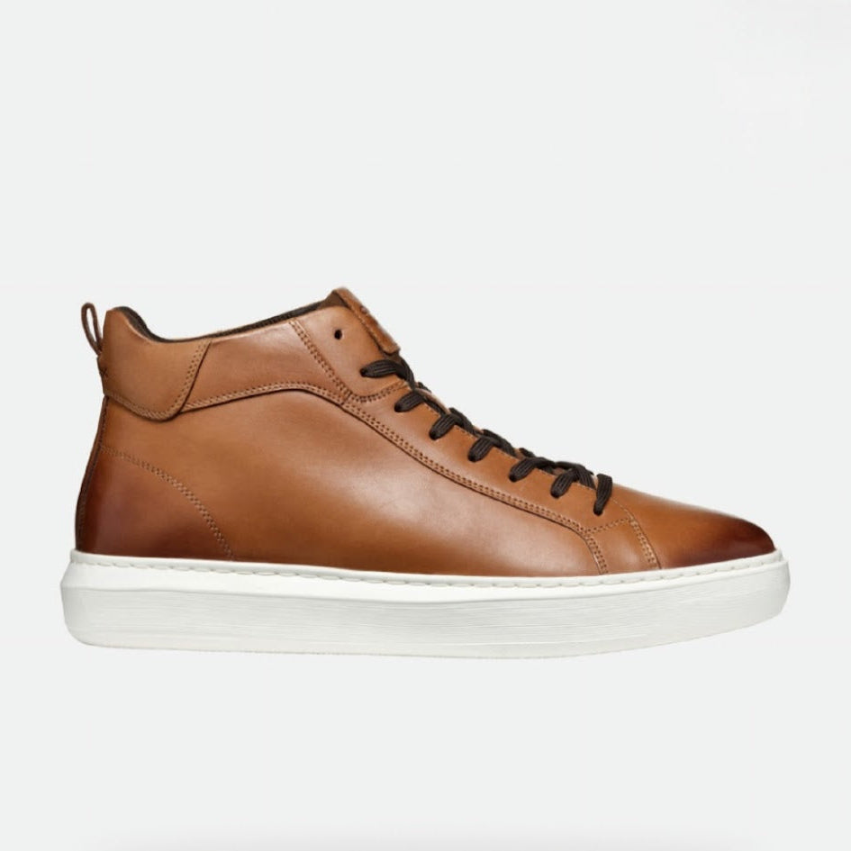 Brown leather ankle boot with white sole on a light gray background