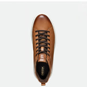 Brown leather sneaker with black laces on a white background