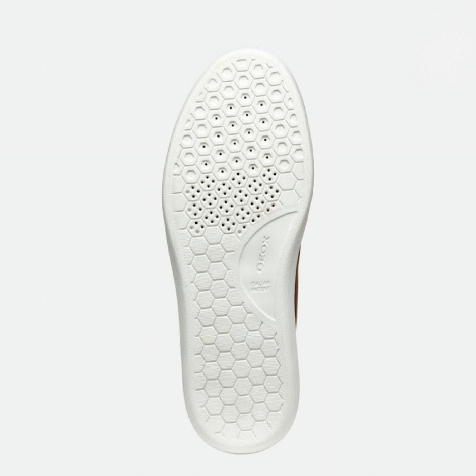 White shoe sole with honeycomb pattern on a light gray background