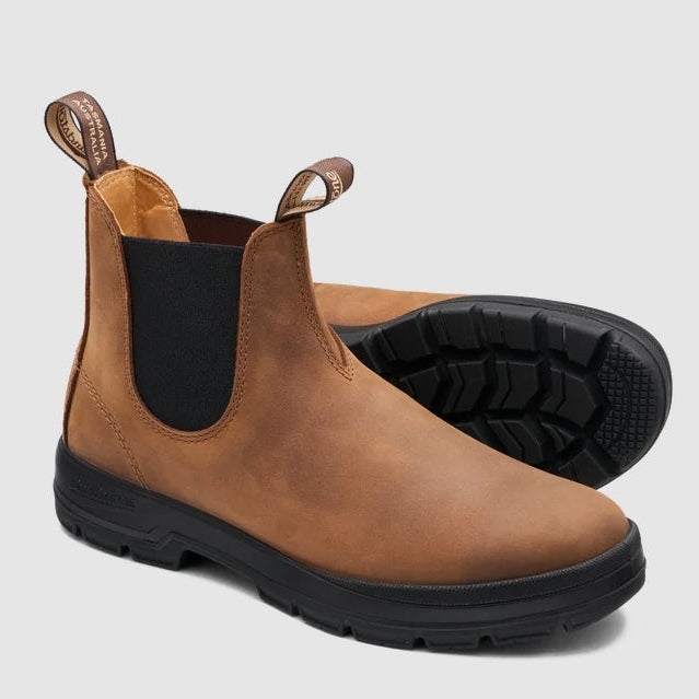 A pair of brown leather Chelsea boots with black elastic side panels and black rubber soles, shown on a light gray background.