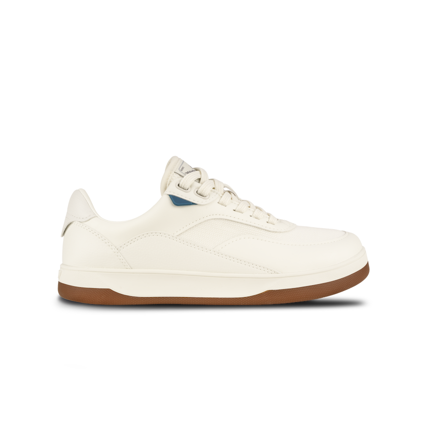 White sneaker with brown sole on a white background