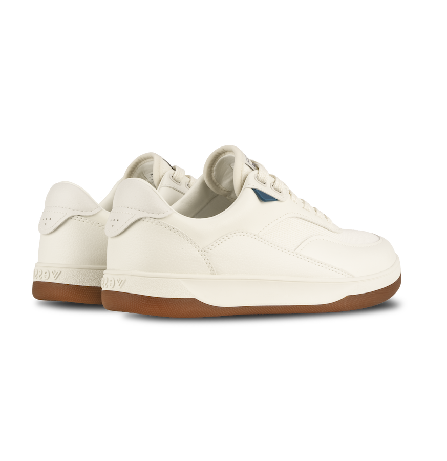 White sneakers with brown soles on a white background
