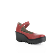 A red Mary Jane style platform wedge shoe with a black lug sole, shown from a three-quarters angle on a white background.