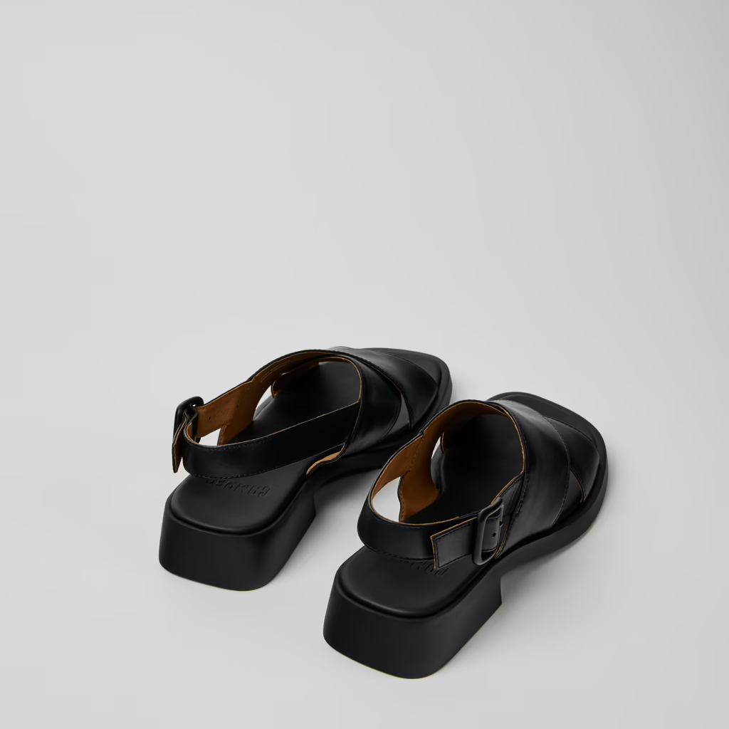 Pair of black sandals on a light gray background