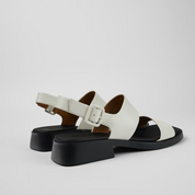 Black and white sandals on a light gray background