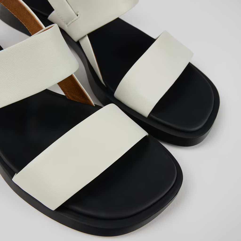 Black and white sandals on a light gray background