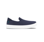 Navy slip-on shoe with white sole on a white background
