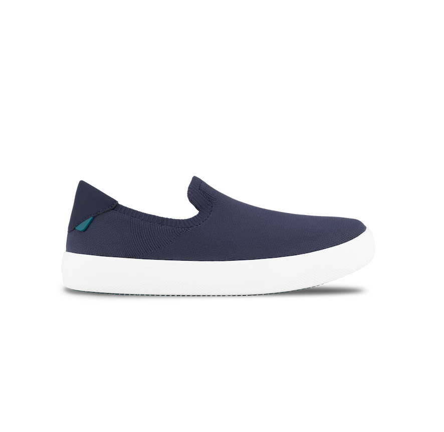Navy slip-on shoe with white sole on a white background
