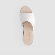 White sandal with beige heel and 'Jelly' branding on a light gray background