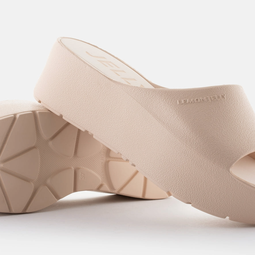 Beige wedge sandals on a light gray background