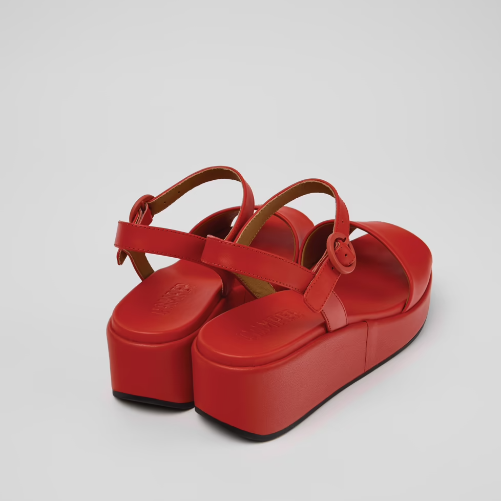 Red platform sandals on a light gray background
