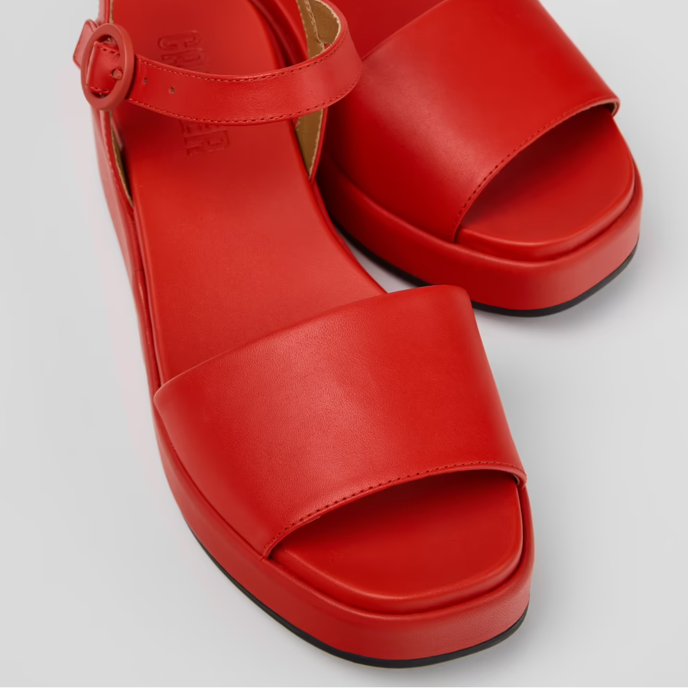 Red sandals with a platform sole on a light gray background