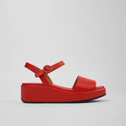 Red sandal with a platform sole on a light gray background
