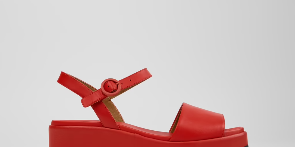 Red sandal with a platform sole on a light gray background