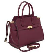 Maroon handbag with gold accents on a white background